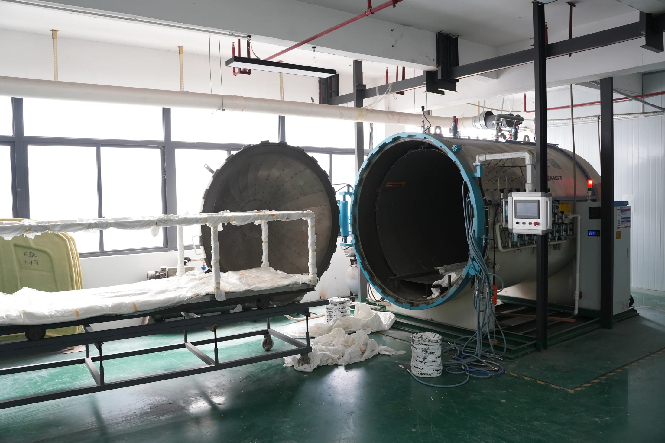 CMST's two vacuum curing vessels with a loaded parts trolley