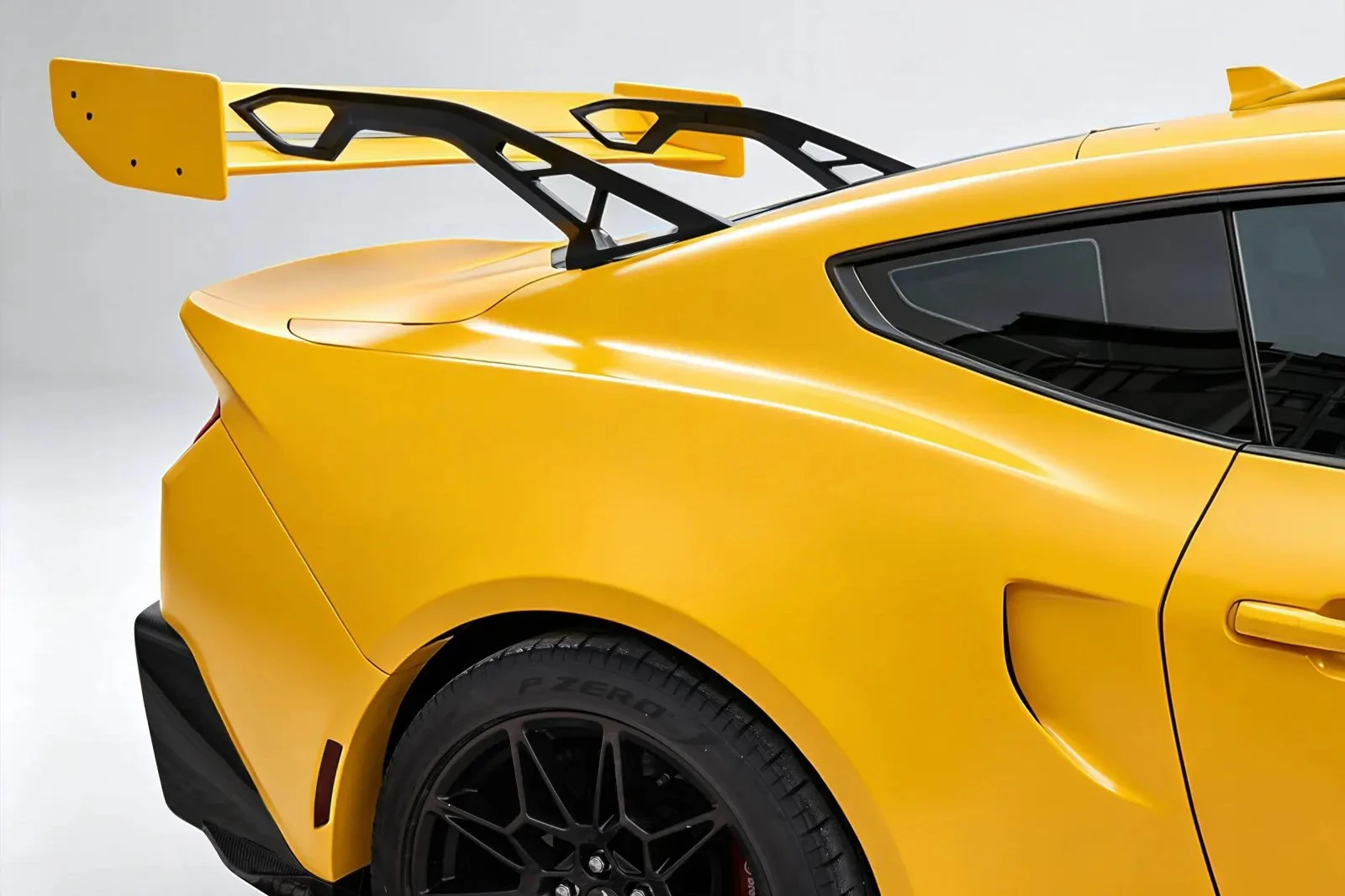 Close-up of a CMST widebody conversion — flared rear arch and GT wing, studio shot